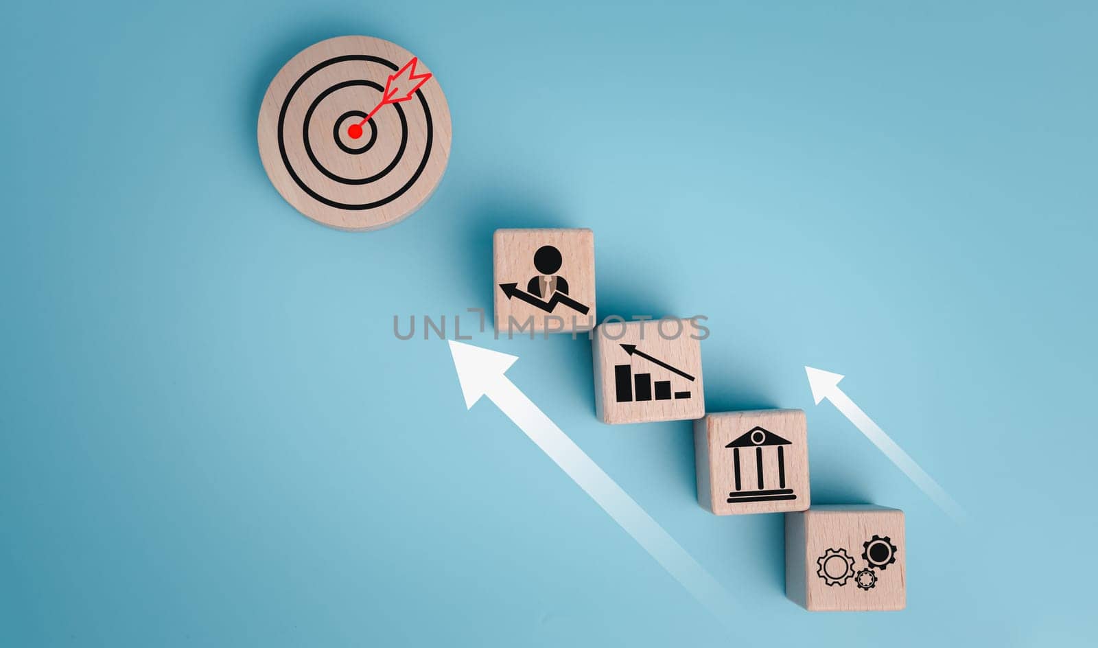 Circular wood with printed target icons and business symbols on white background, business goals and objectives concept, business competition.