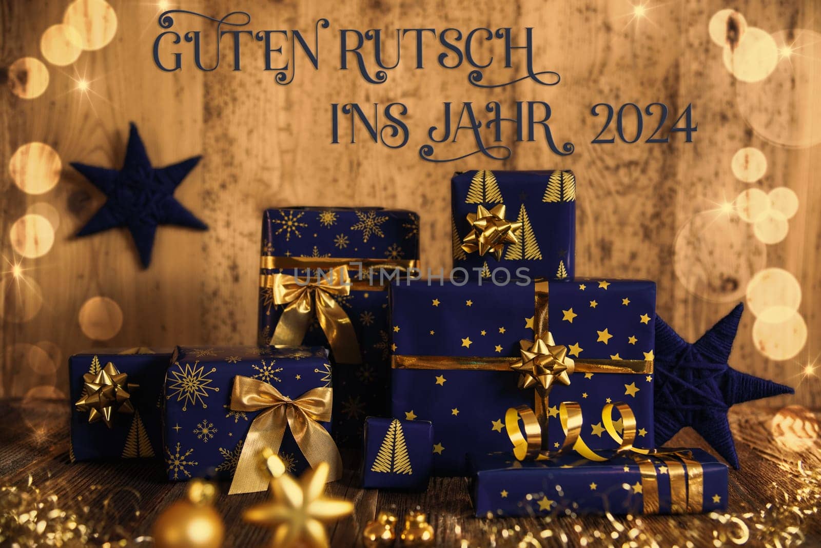 German Text Guten Rutsch Ins Jahr 2024, Means Happy New Year 2024 In English, Many Blue Christmas Presents, Christmas Background, Wooden Winter Decor
