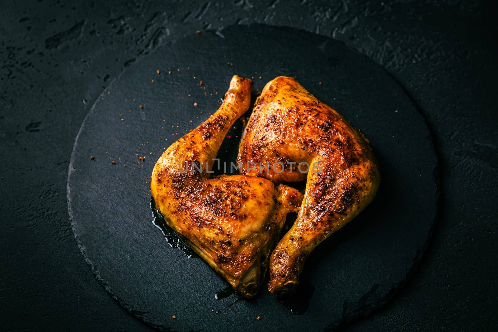 BBQ grilled chicken legs on black background