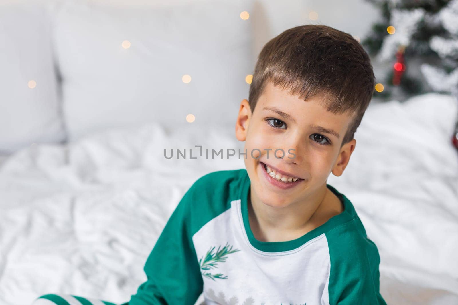 Beautiful child boy playing in decorated home for Christmas, enjoying holidays at home. Generation Alpha and Gen Alpha.