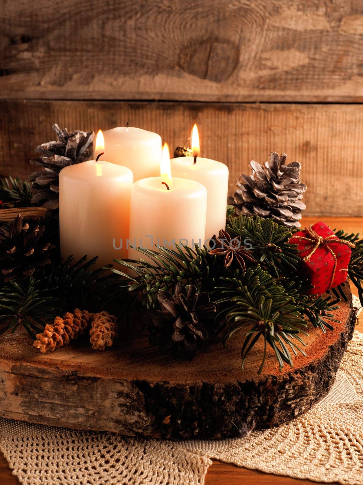 Third Advent, one candle burning on a rustic wooden table with Christmas decoration