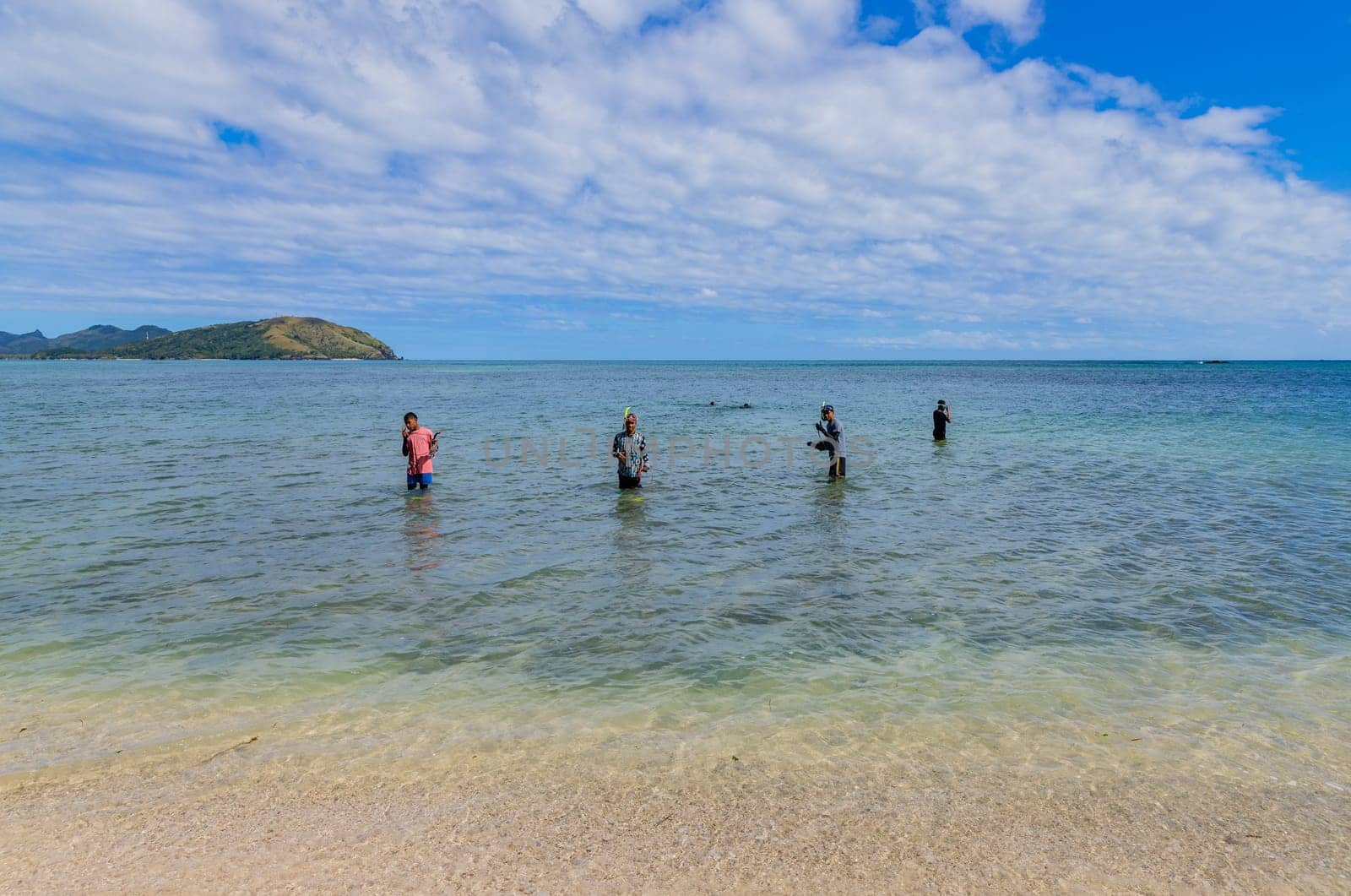 Nacula, Fiji: 26 May 2023: Local kids fishing at the beach, Nacula island in Fiji.