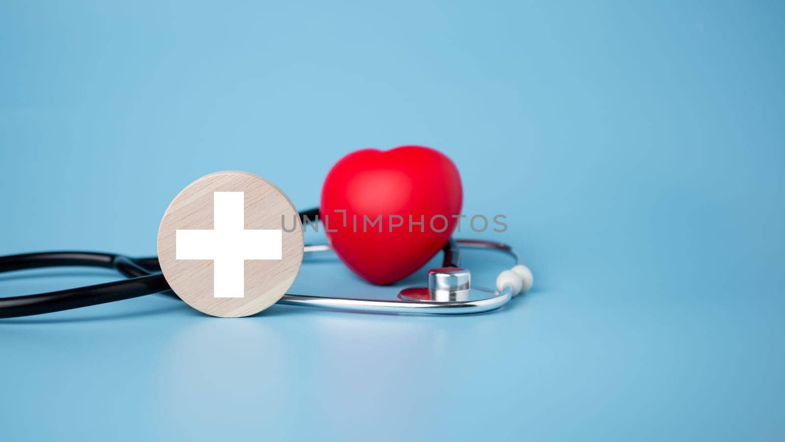 The concept of health insurance and medical welfare. Circle wood and red heart with icon. Health insurance and access to health care.