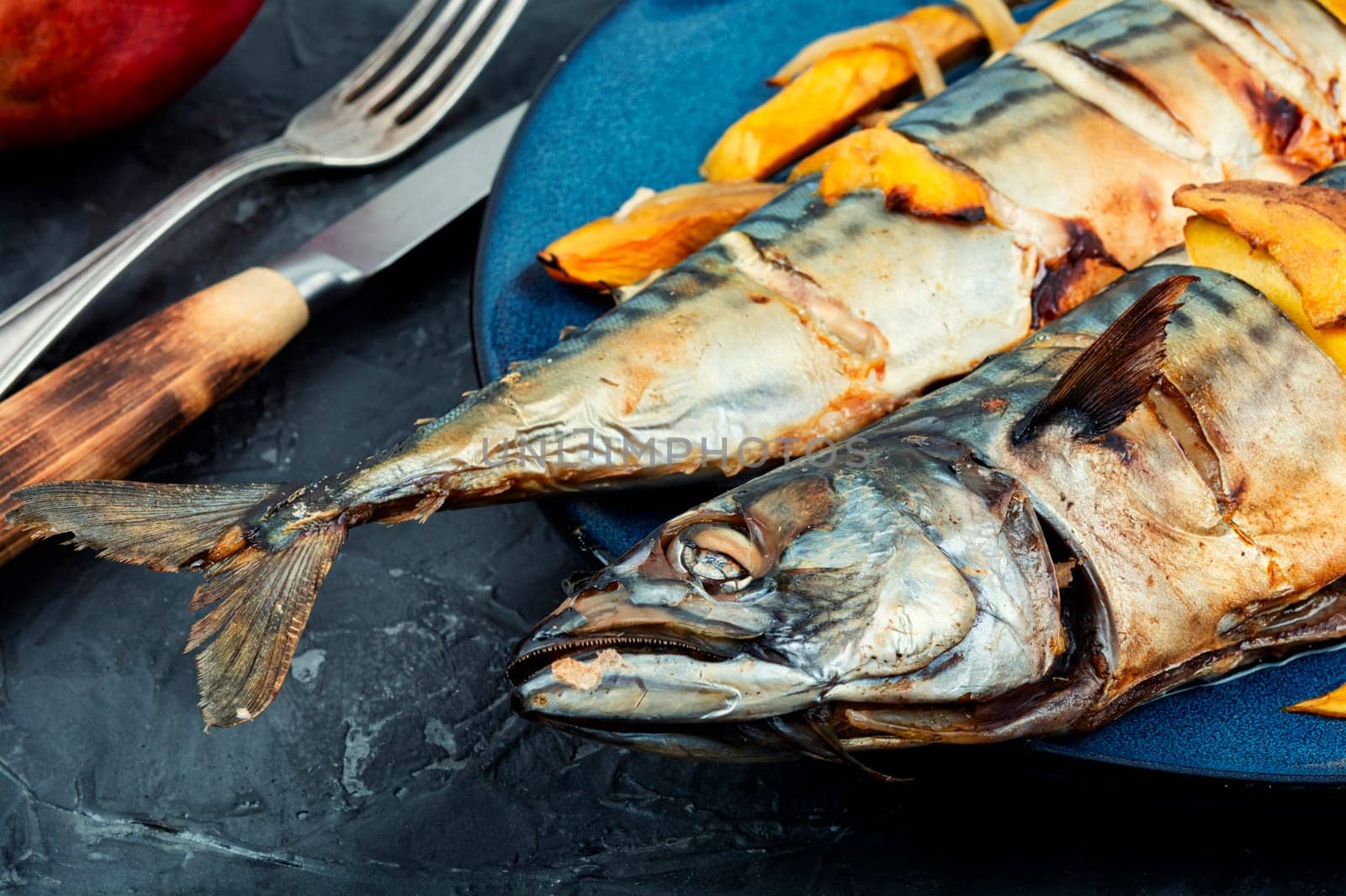 Appetizing mackerel fish roasted with mango. Healthy homemade food. Cookbook recipe.