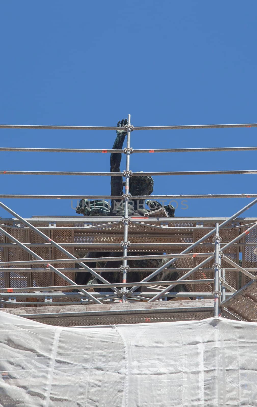 Cornice sculpture covered with scaffoldings. Heritage preservation concept