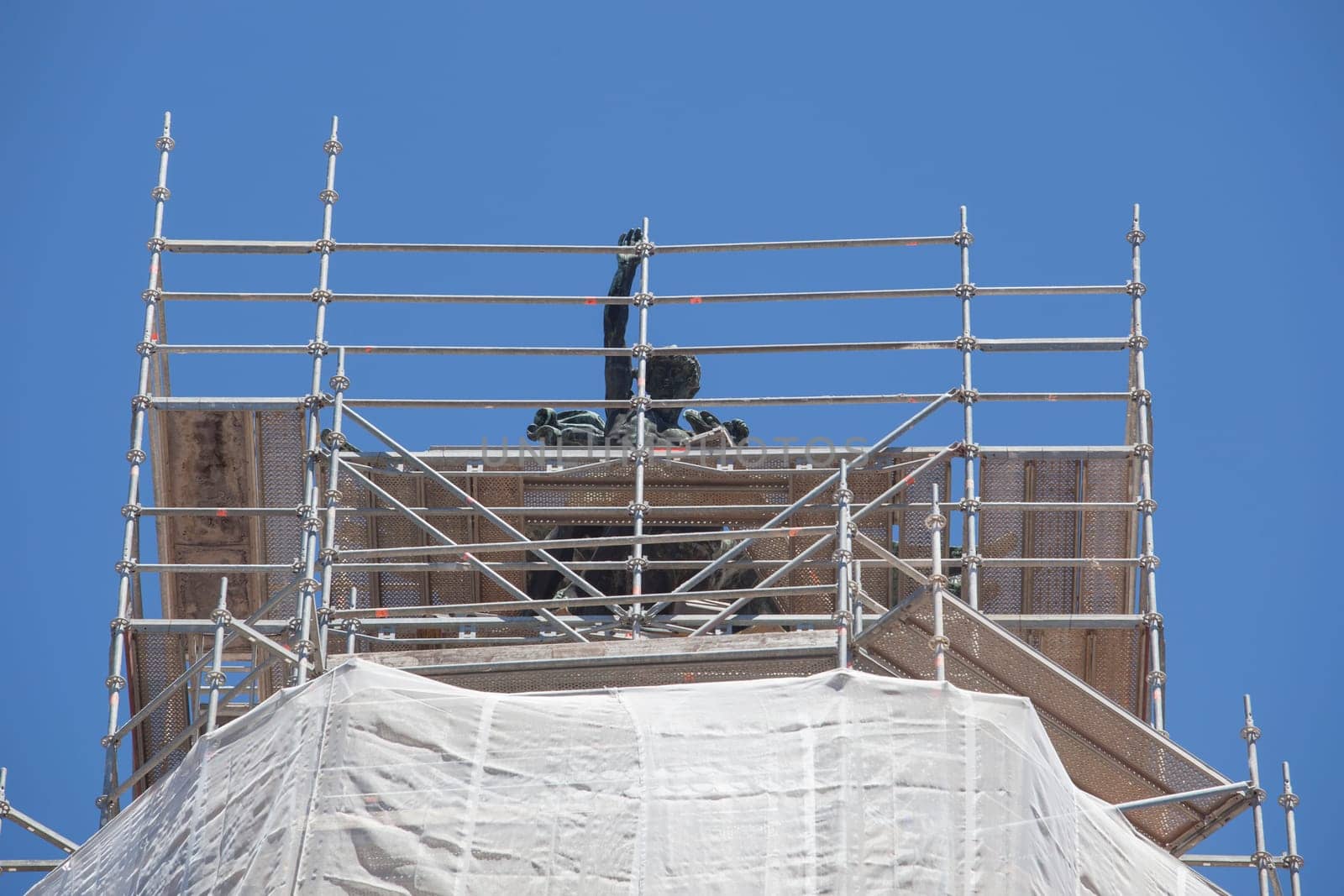 Cornice sculpture covered with scaffoldings. Heritage preservation concept
