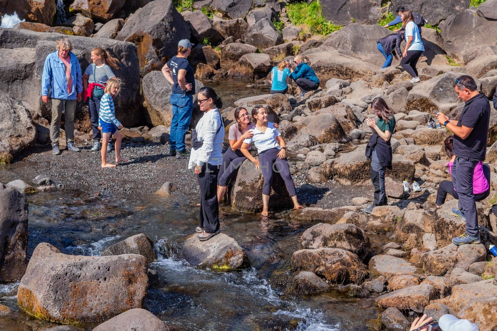 People at the Oxararfoss waterfalls in Iceland. Oxarafoss also called Oxararfoss is located in the Thingvellir National Park on the Oxara River.