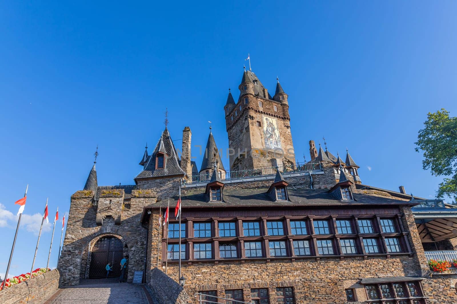 Cochem, Germany, August 10, 2023. Beautiful view of the hilltop castle (Reichsburg Cochem) in the touristic town of Cochem on the Moselle River in Rhineland-Palatinate in Germany.