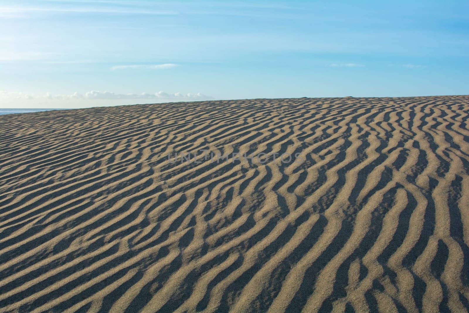 Lines in the desert sand with blue sky