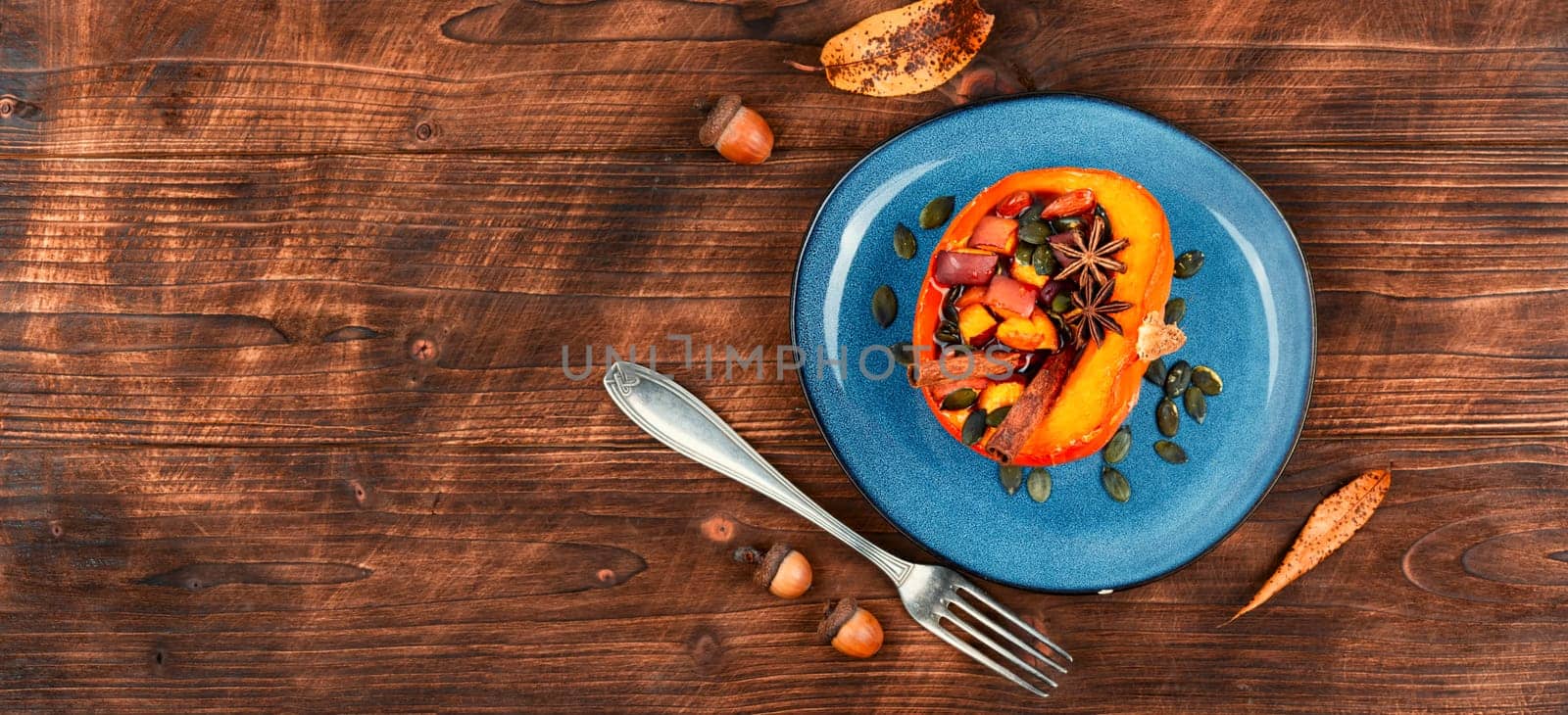 Tasty pumpkin baked with apples, peaches and cinnamon. Autumn recipe, baked squash. Healthy food