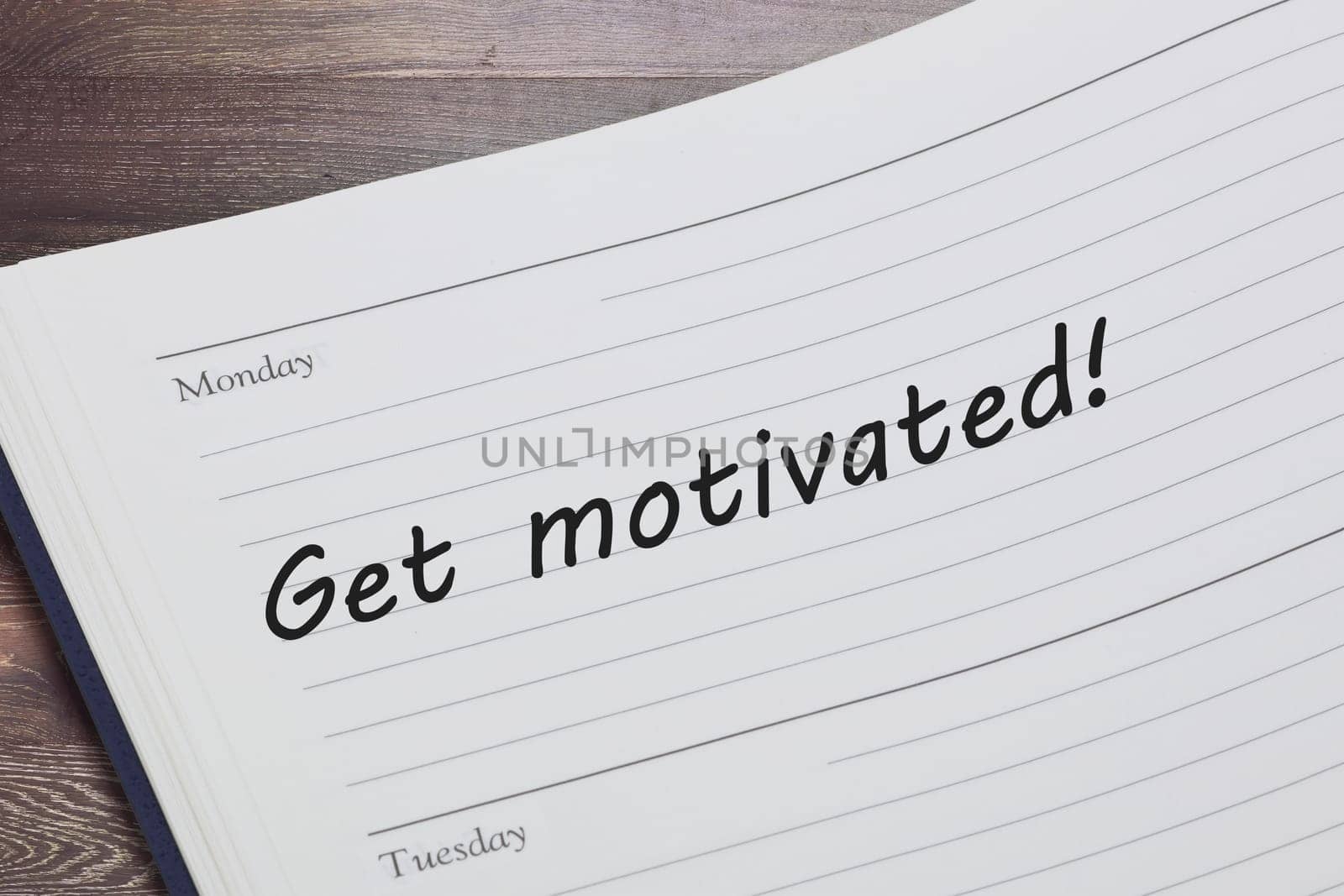 A Get motivated concept diary reminder open on a desk