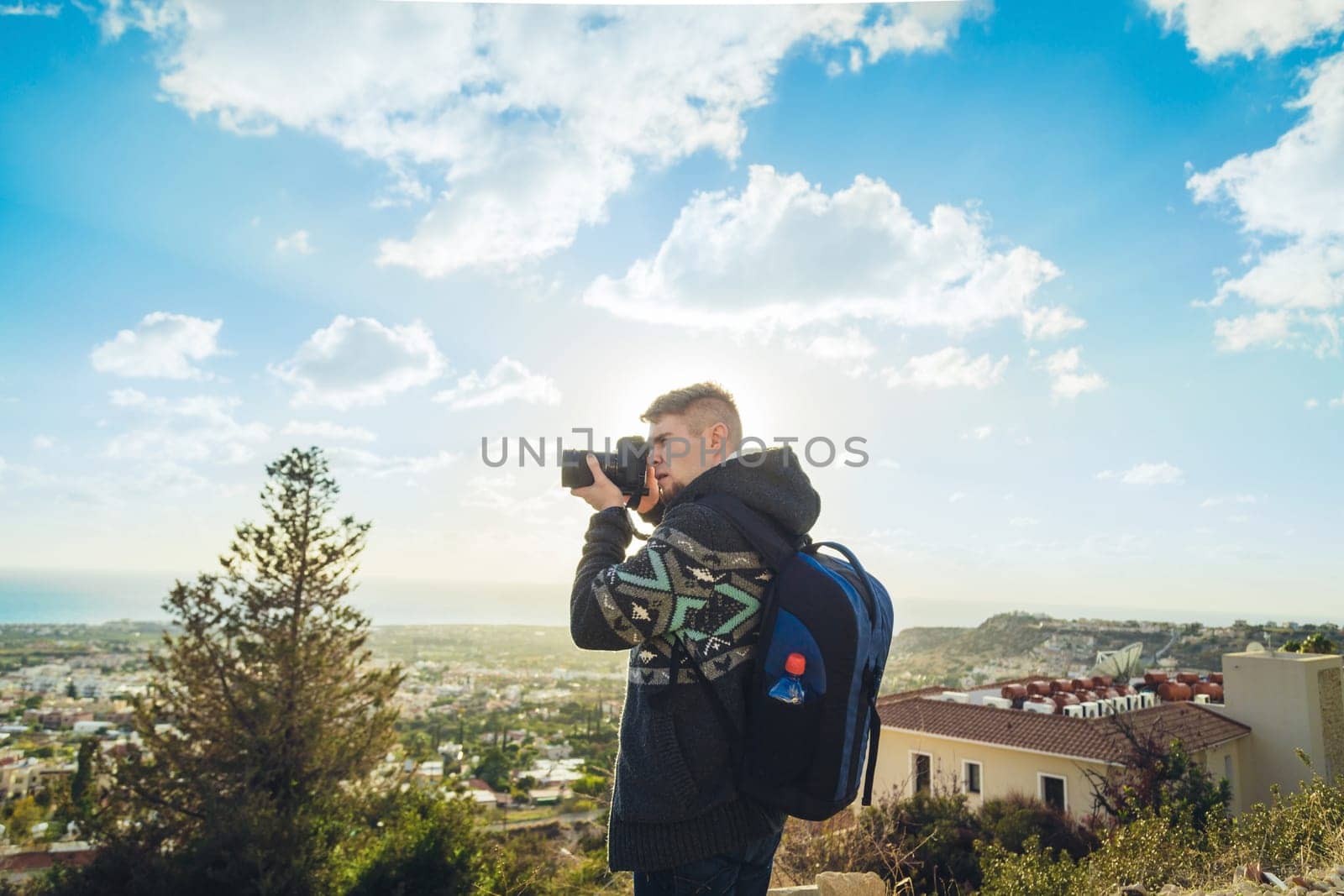 Traveler photographer with digital camera on top of the mountain