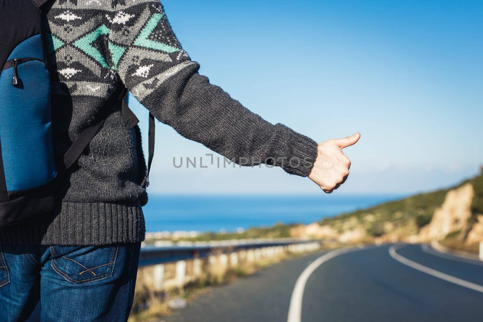 road trip, travel, gesture and people concept - hitchhiker stopping car with thumbs up hand sign.