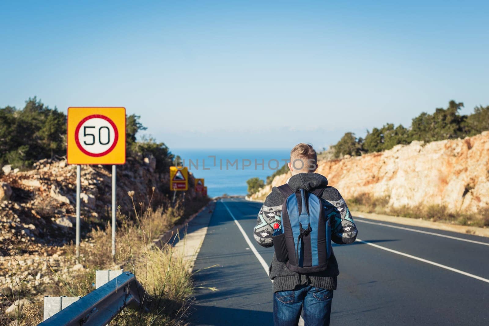 Young Hitchhiking travel man at the route.