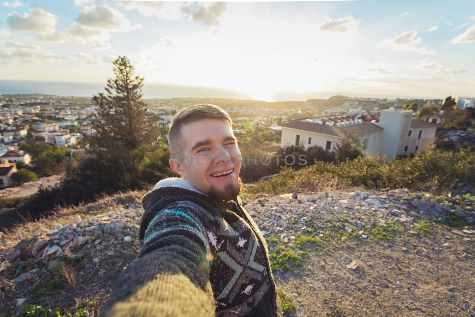 Handsome bearded man taking selfie. Happy student makes funny picture for his blog