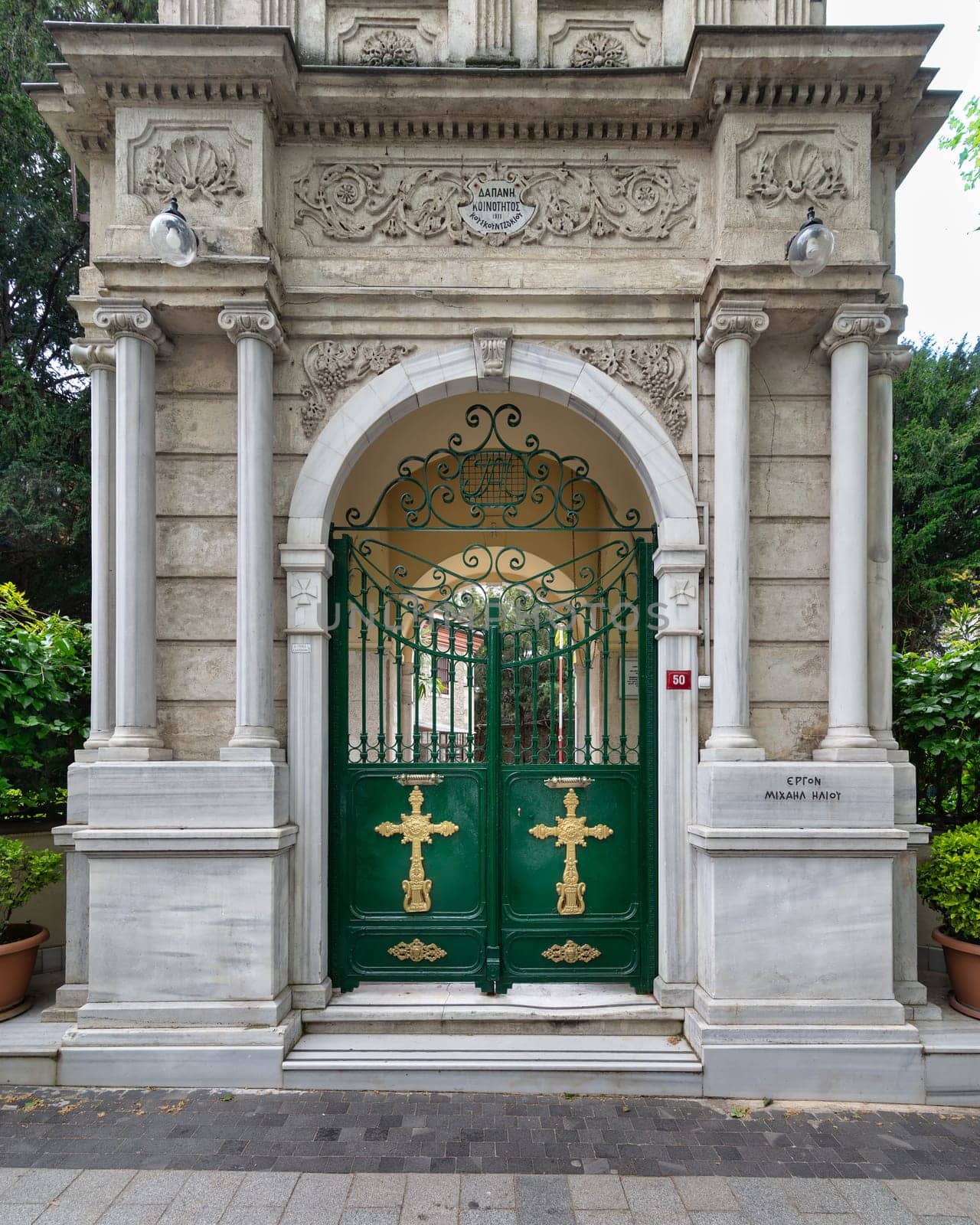 Green Gate with Gold Crosses framed by elegant marble decorations, at the Entrance of Agios Greek Orthodox Panteleimonas Church, located in Kuzguncuk neighborhood, Uskudar, Istanbul, Turkey
