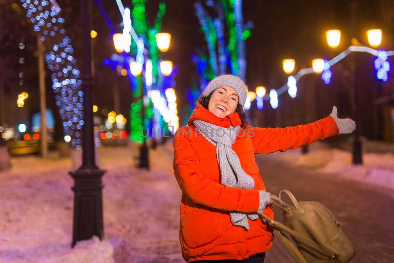 pretty funny girl having fun outdoor in winter. Christmas, city and winter holidays concept.