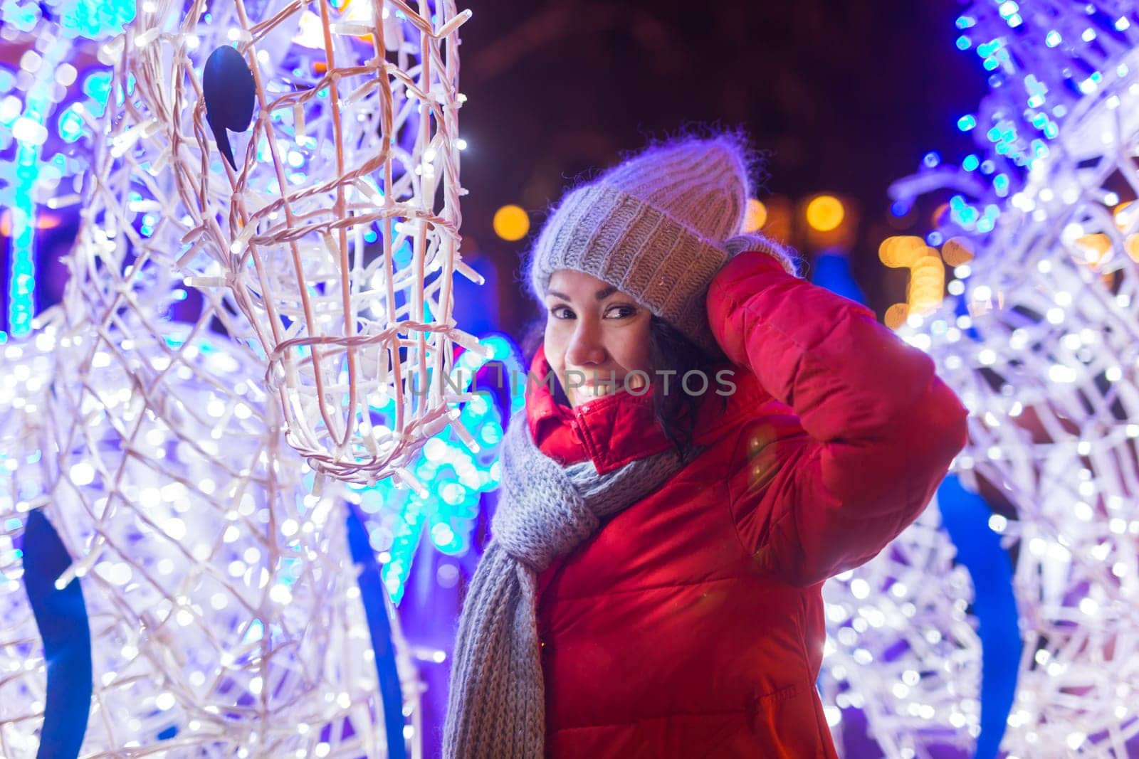 Girl in a night city snowflake Christmas city lights. Christmas and winter holidays.