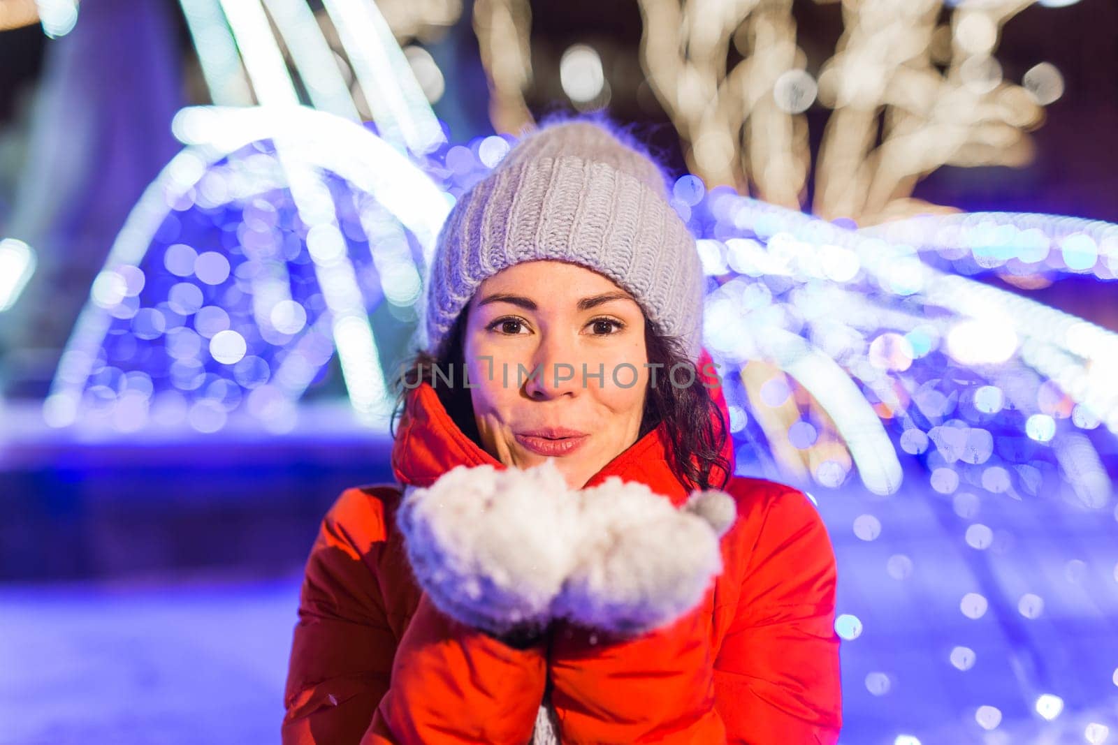 pretty funny girl having fun outdoor in winter. Christmas, city and winter holidays concept.