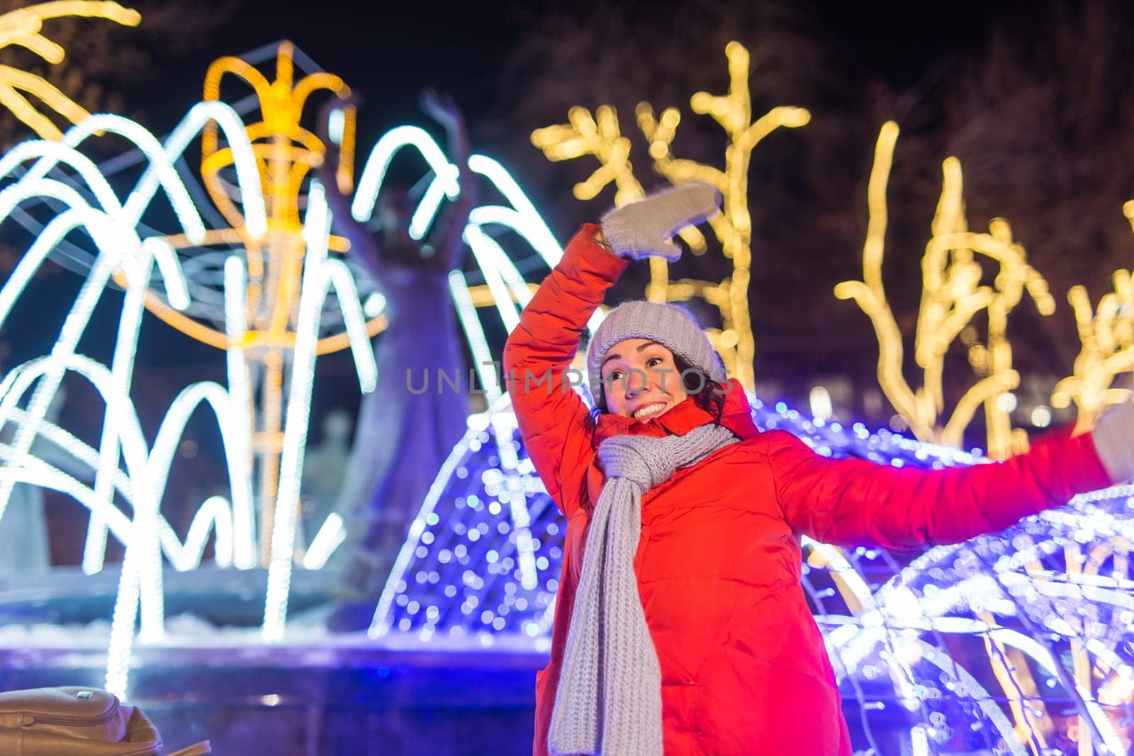 Girl in a night city snowflake Christmas city lights. Christmas and winter holidays.