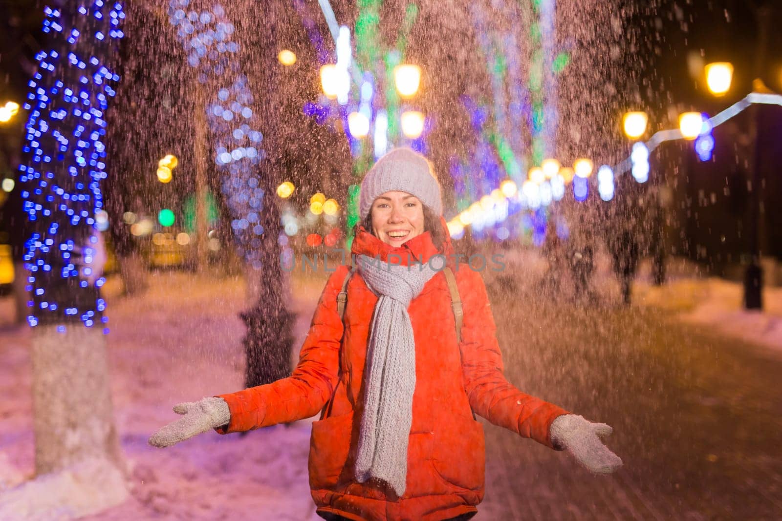 pretty funny girl having fun outdoor in winter. Christmas, city and winter holidays concept.