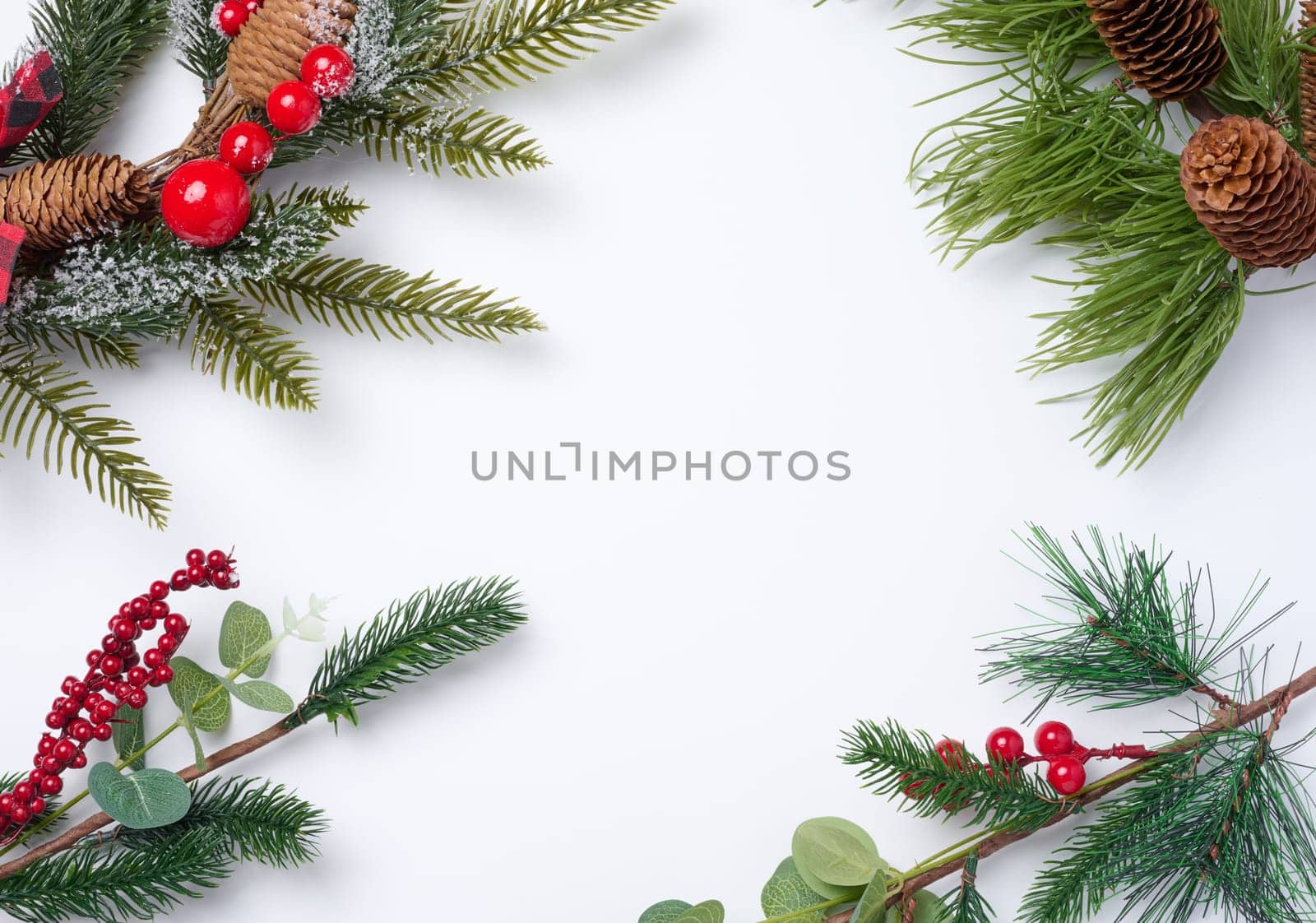 Christmas fir branches with decor on a white background, top view