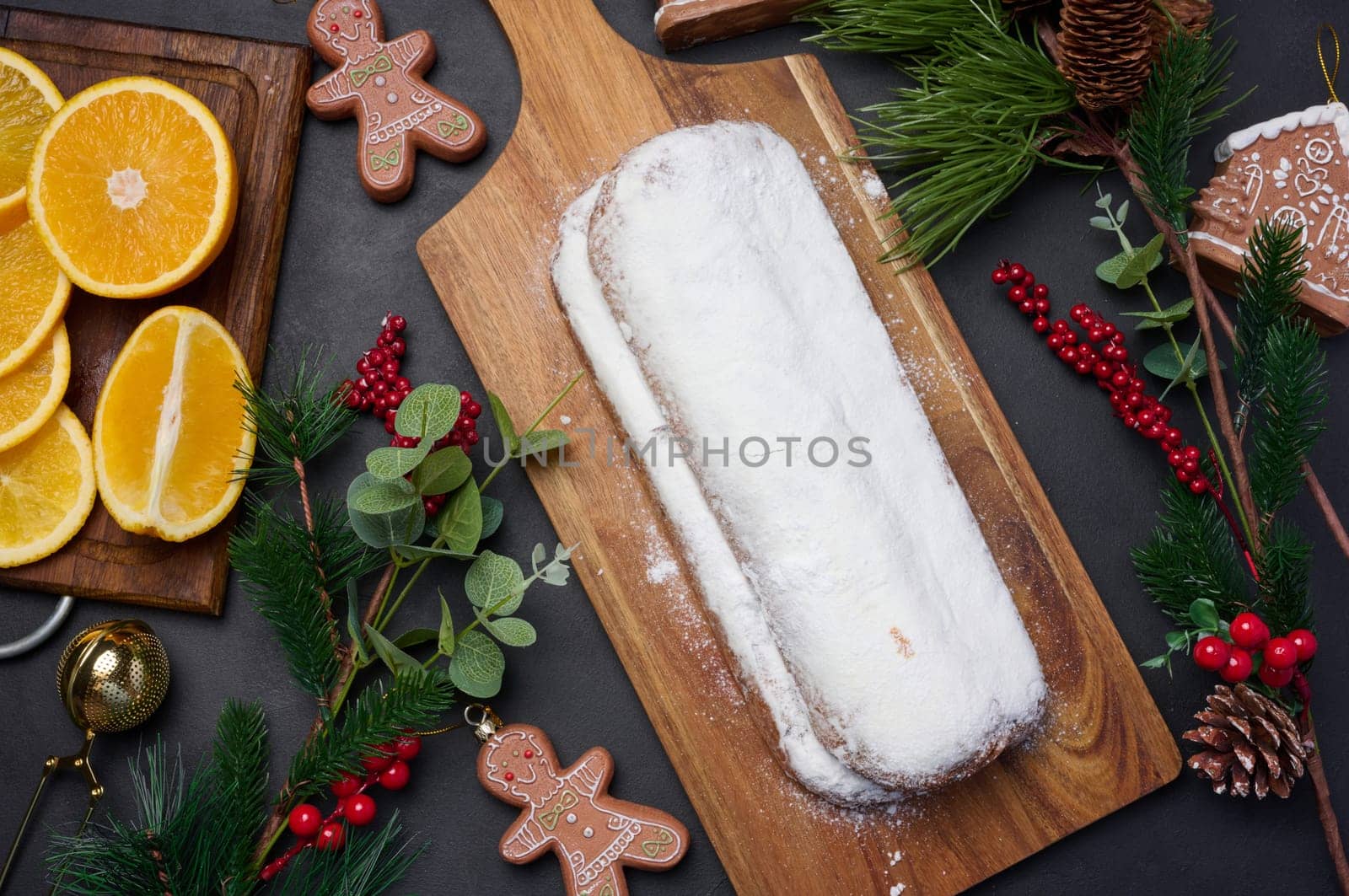 Christmas pastries stollen sprinkled with powdered sugar on the table, festive dessert