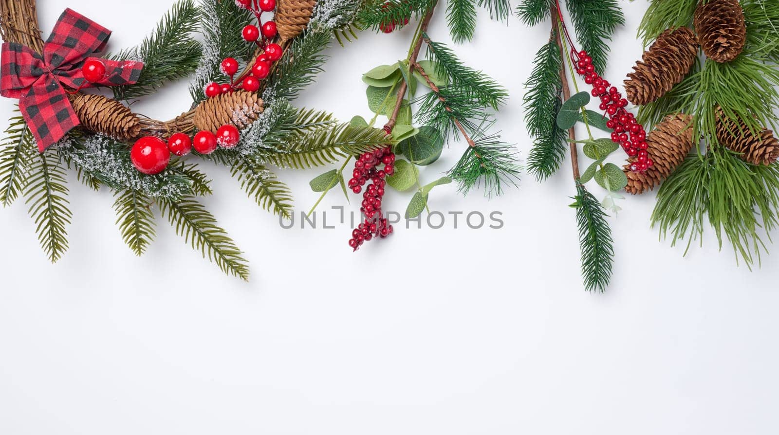 Christmas fir branches with decor on a white background, top view. Copy space