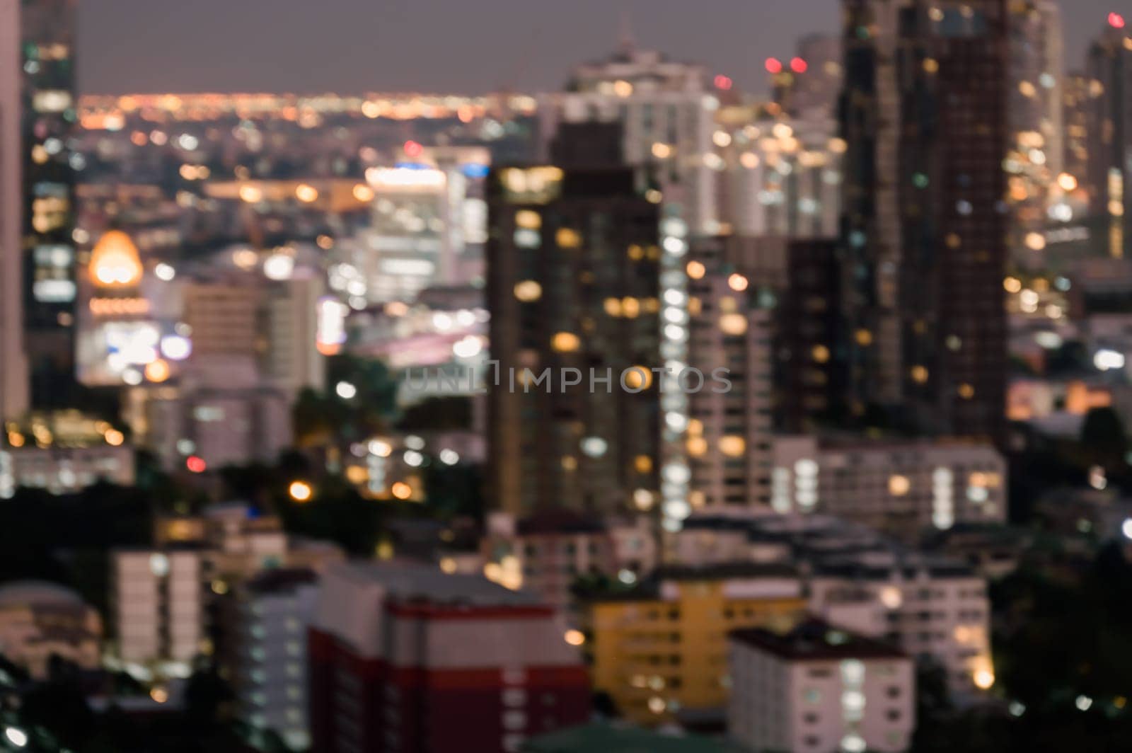 Cityscape blurred abstract background with bokeh urban lights at twilight