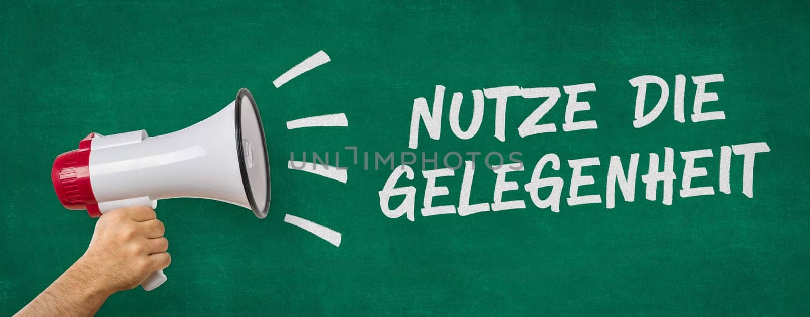 A man holding a megaphone - Take the opportunity in german - Nutze die Gelegenheit
