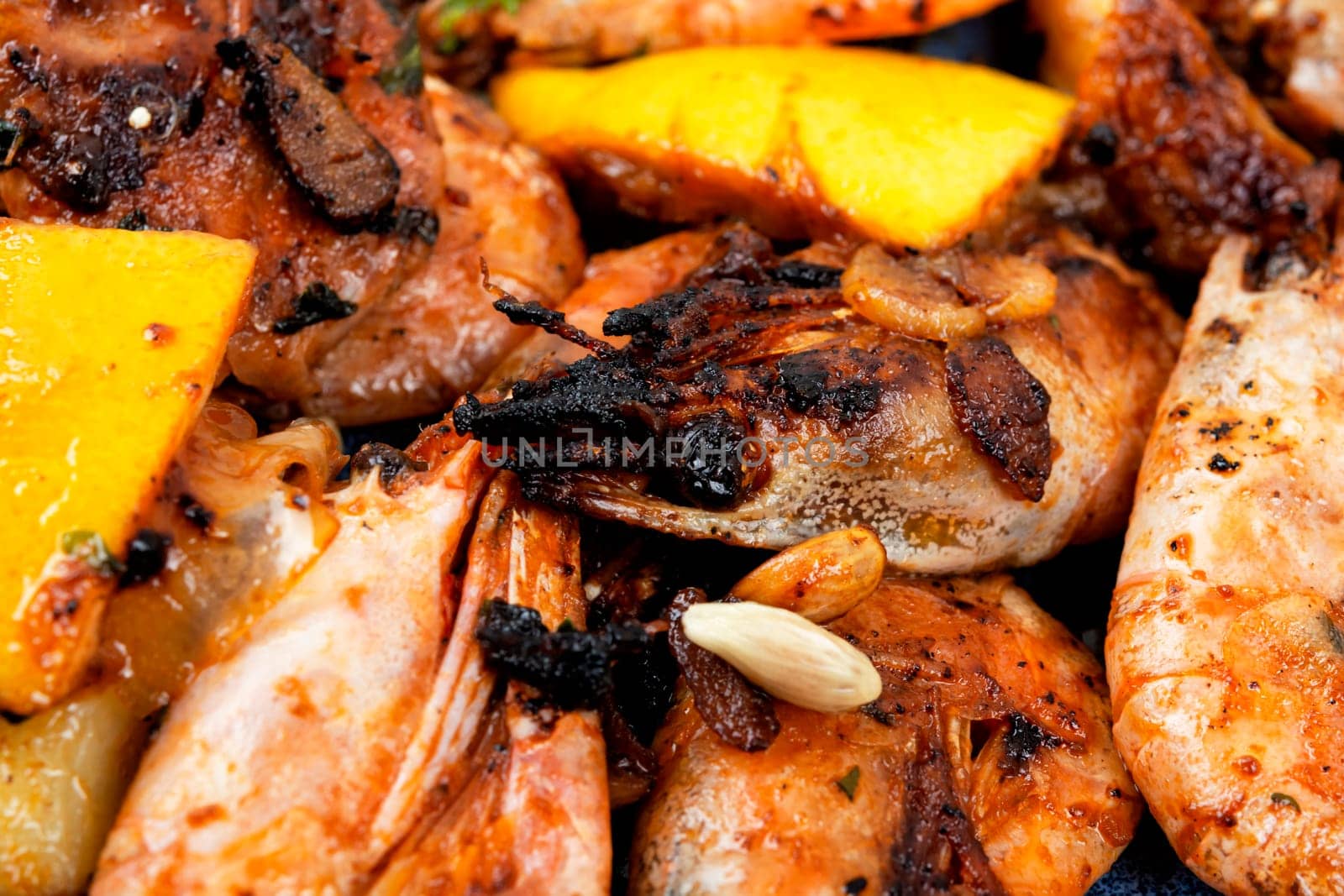 Roasted unpeeled shrimp on a plate. Grilled prawns or shrimps, seafood.
