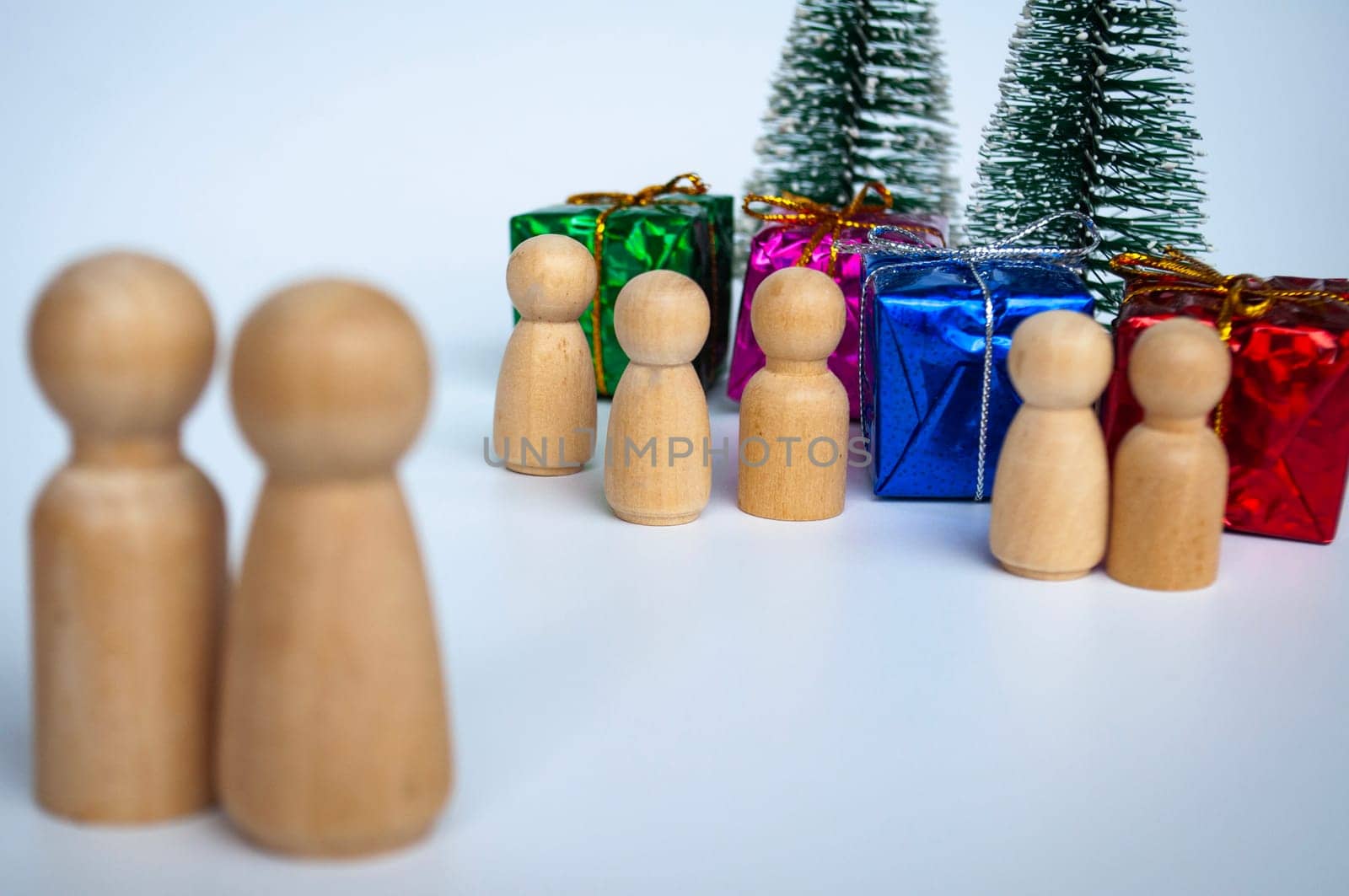 Father and mother giving out presents to their children during Christmas day.