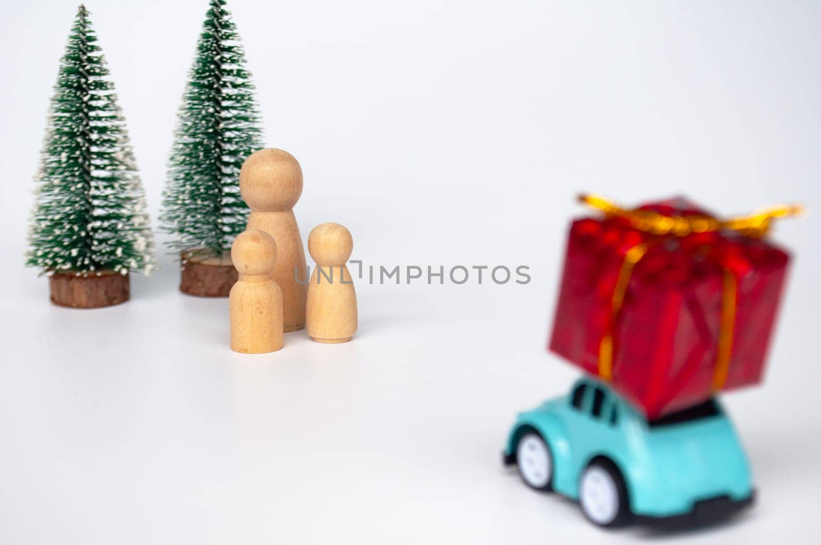 Mother, daughter, and son eagerly await their father return for Christmas with present.