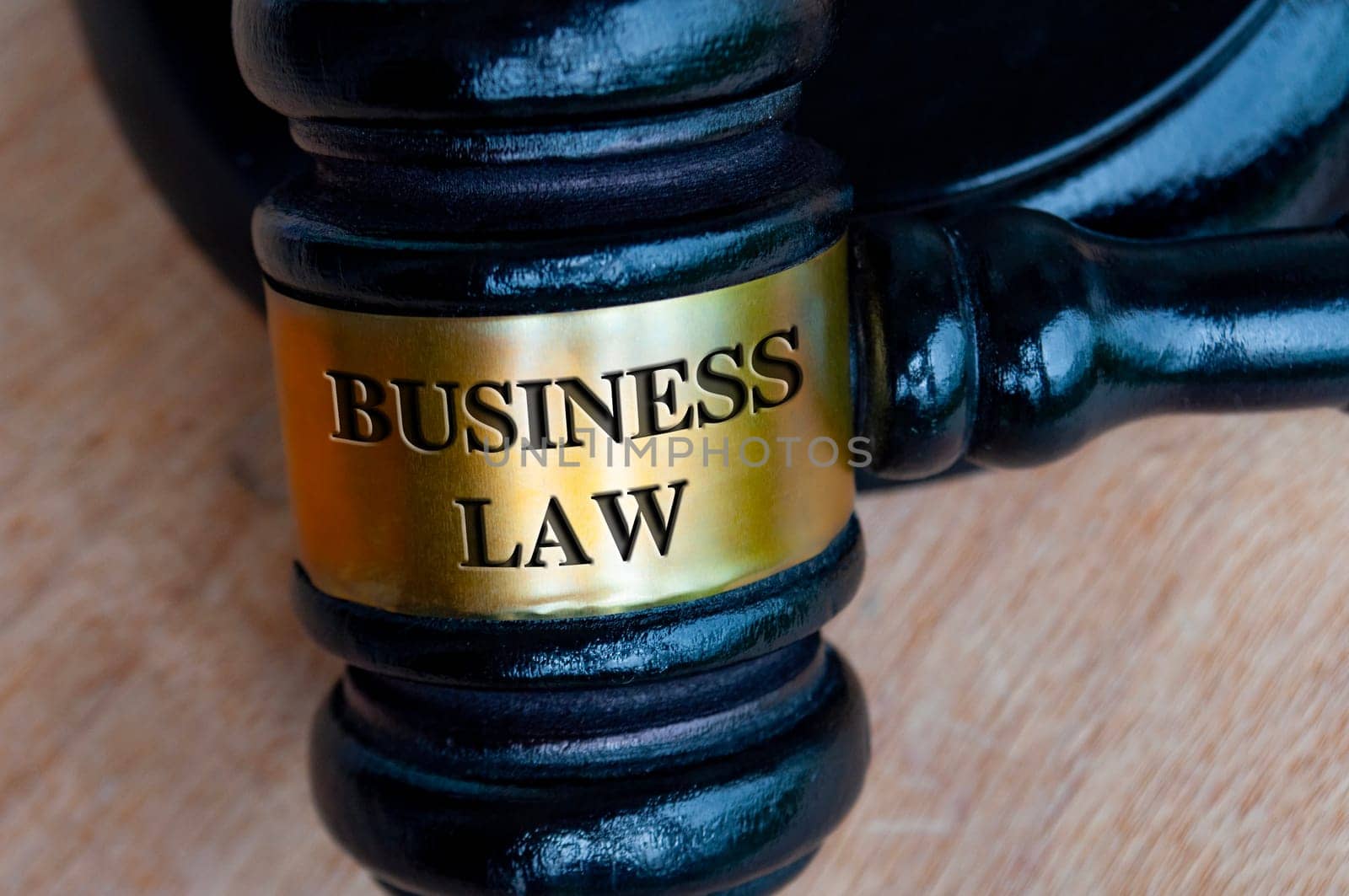 Business law text engraved on gavel. Business law and legal concept.