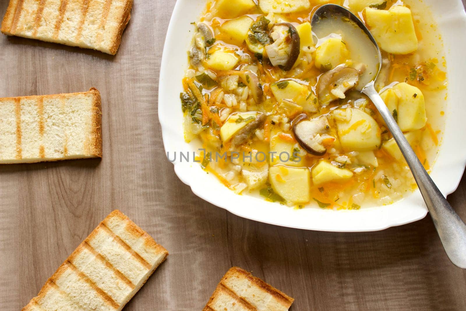 Mushroom soup in a white bowl on a beige background