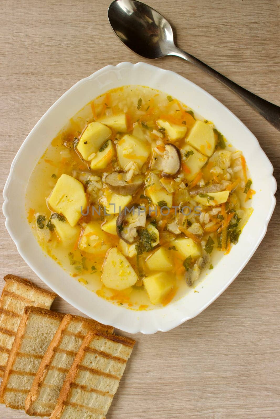 Mushroom soup in a white bowl on a beige background