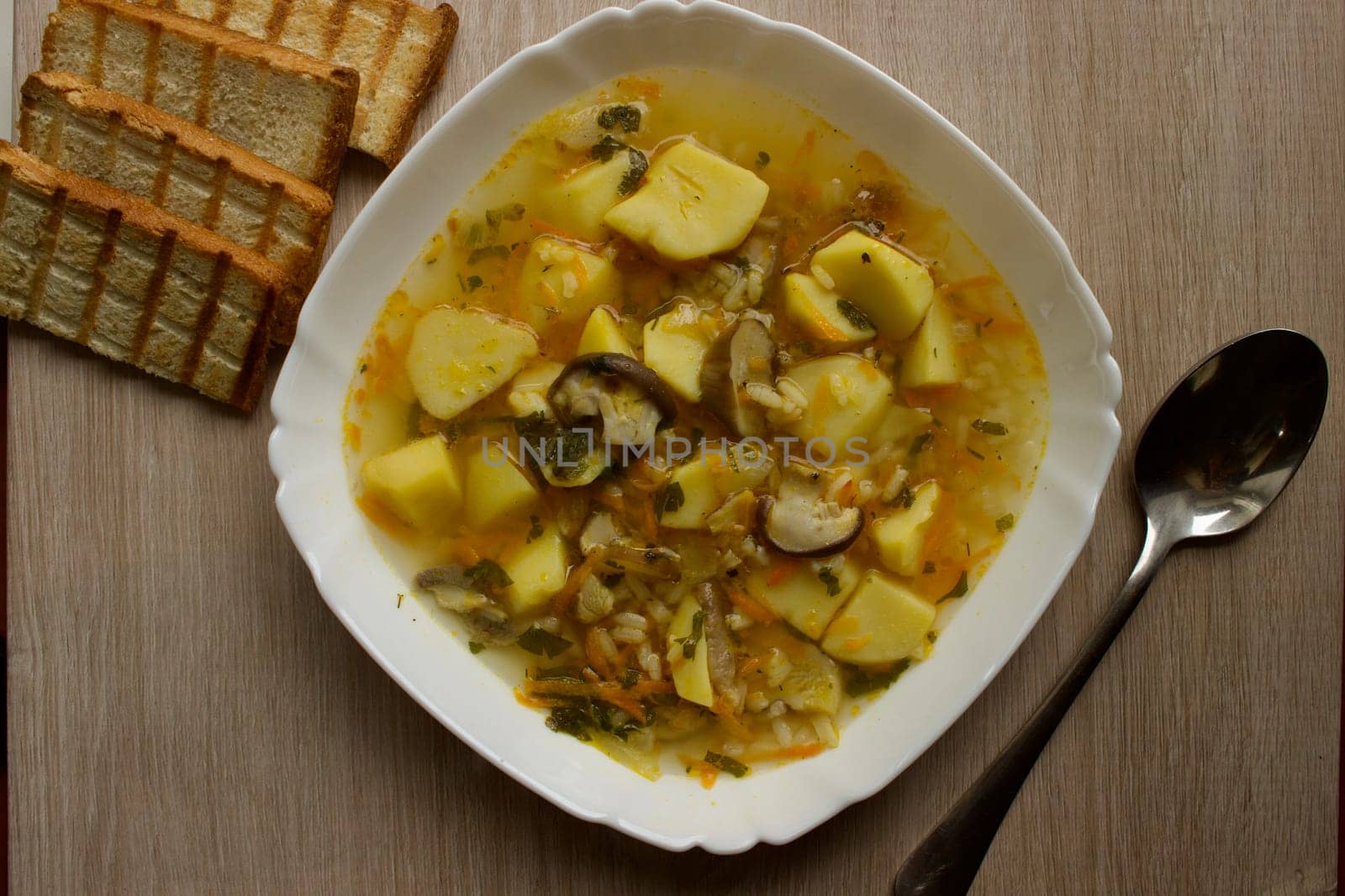 Mushroom soup in a white bowl on a beige background