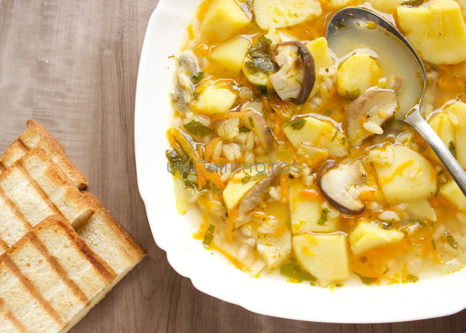 Mushroom soup in a white bowl on a beige background