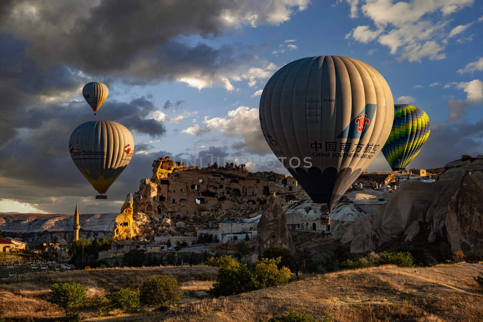 CAVUSIN, TUR - OCT 16, 2023: Hot air balloons near Cavusin in Goreme National Park in Cappadocia, Turkey.