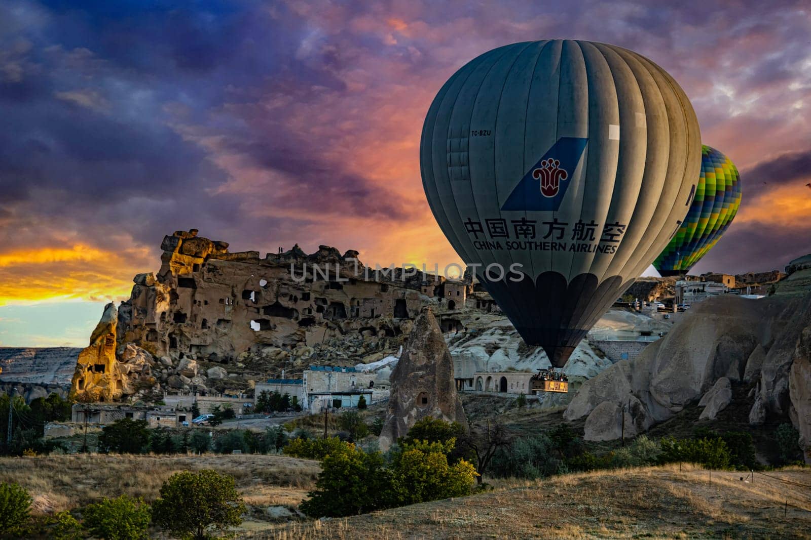 CAVUSIN, TUR - OCT 16, 2023: Hot air balloons near Cavusin in Goreme National Park in Cappadocia, Turkey.