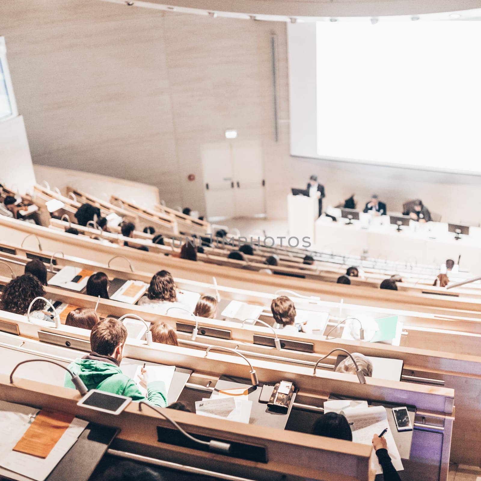 Conference and Presentation. Audience at the conference hall. Business and Entrepreneurship. Faculty lecture and workshop. Audience in the lecture hall. Academic education. Student making notes.