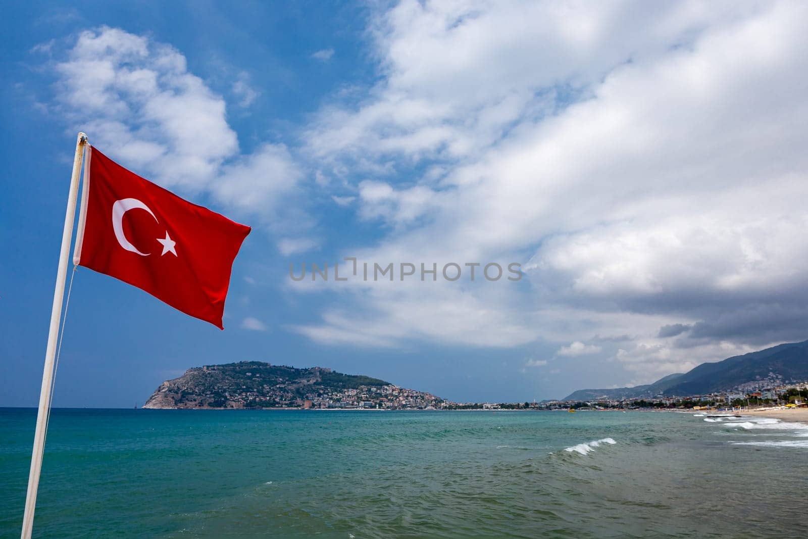 Alanya beach in Turkey, national flag of Turkey, travel landscape