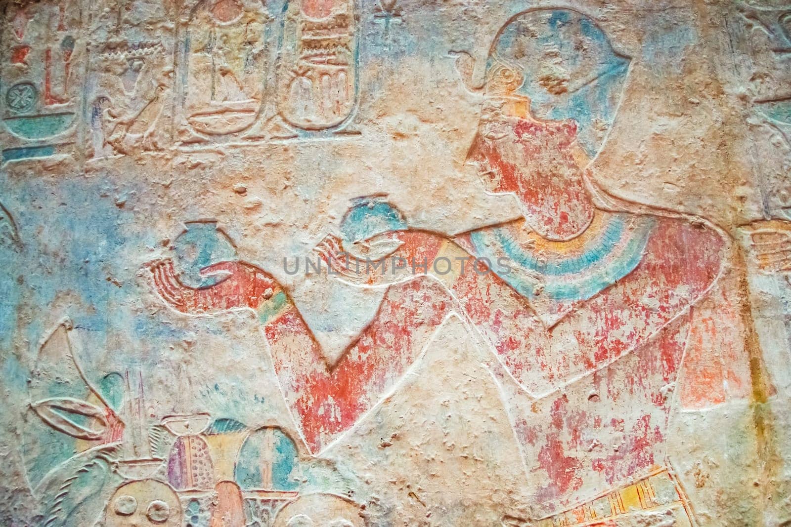 Colorful Egyptian hieroglyphs as an ancient background. Horizontally.