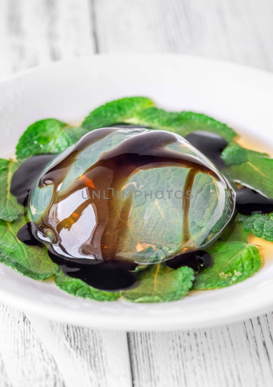 Portion of raindrop cake on mint leaves bad
