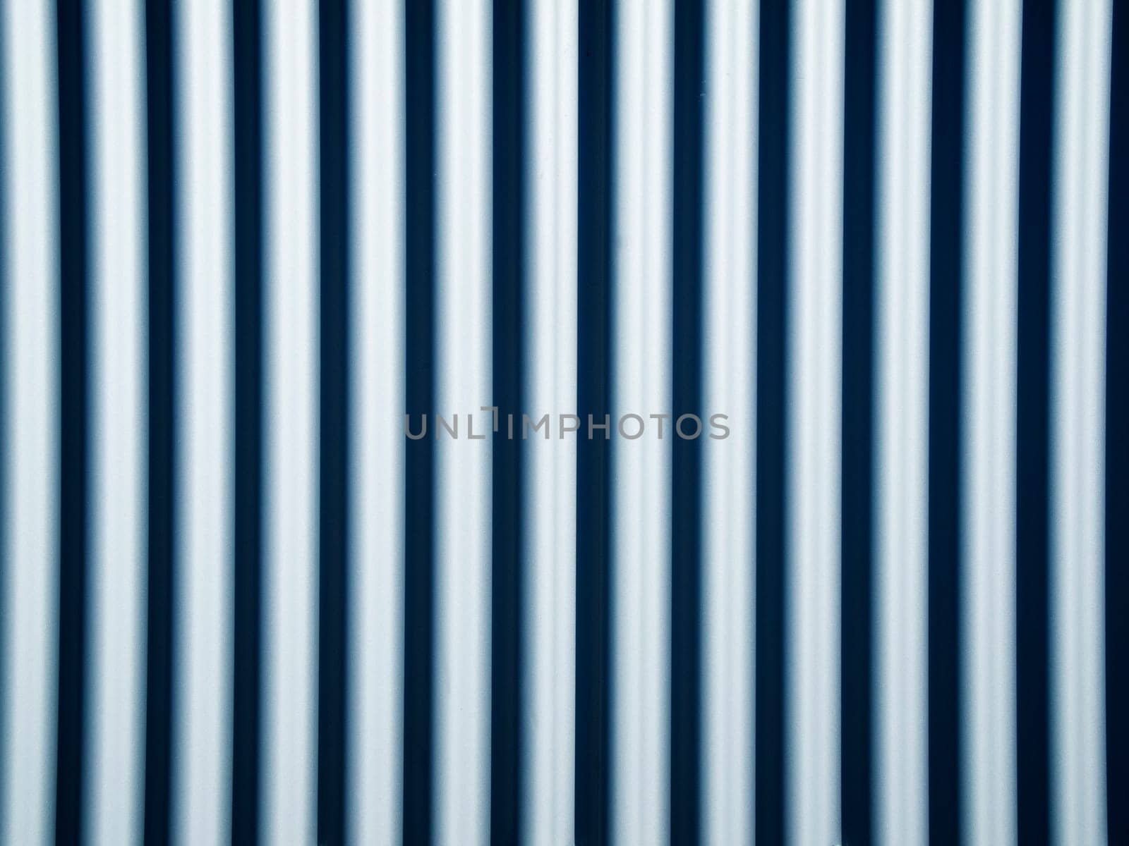 Full format view of a series of pipes arranged evenly in parallel and vertically.