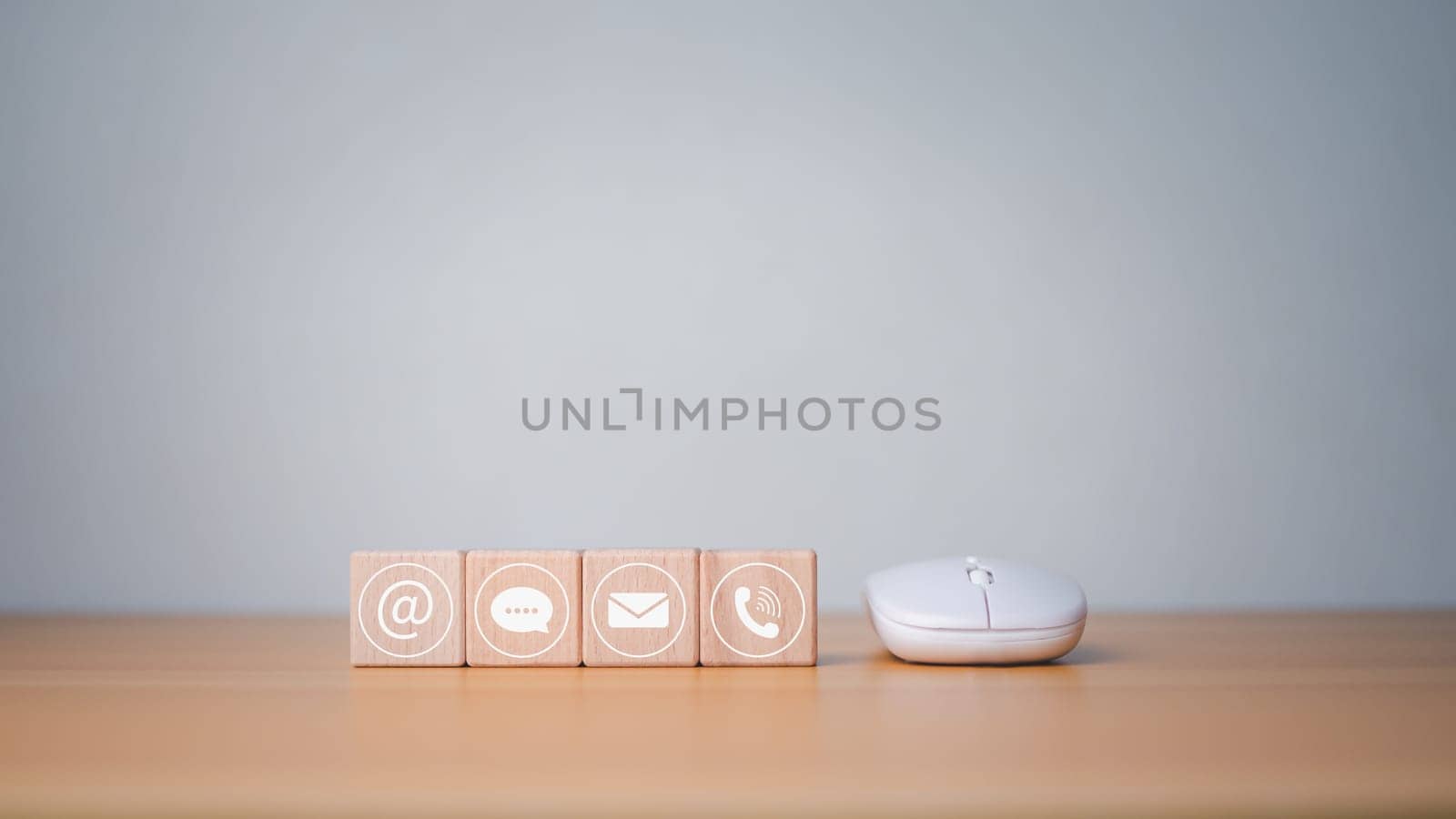 Website page contact us or email marketing concept, customer support hotline, contact us, wooden block printed communication symbol with mouse, email icons, phone, address, chat message.