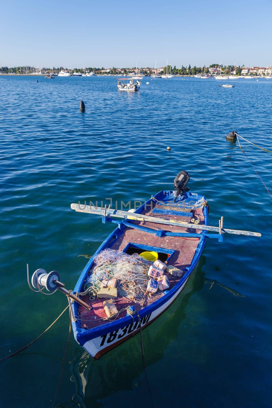 small rowing boat with fishing nets on board on the adriatic sea