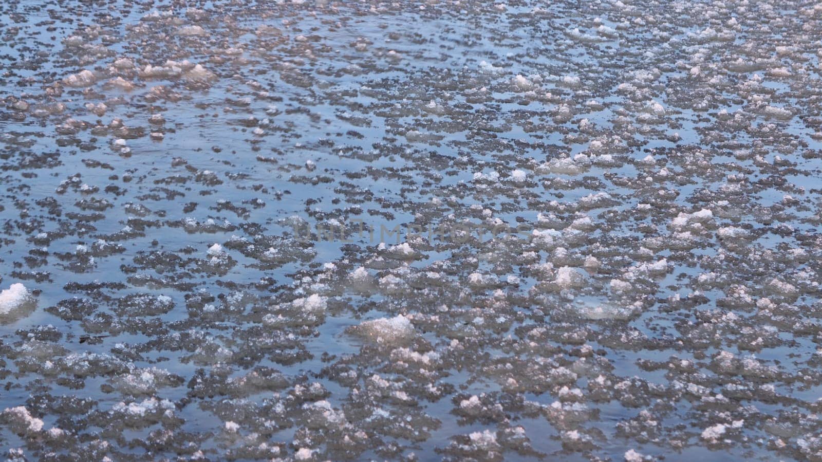 sea waves, ice slush illuminated by sunlight, abstract natural background