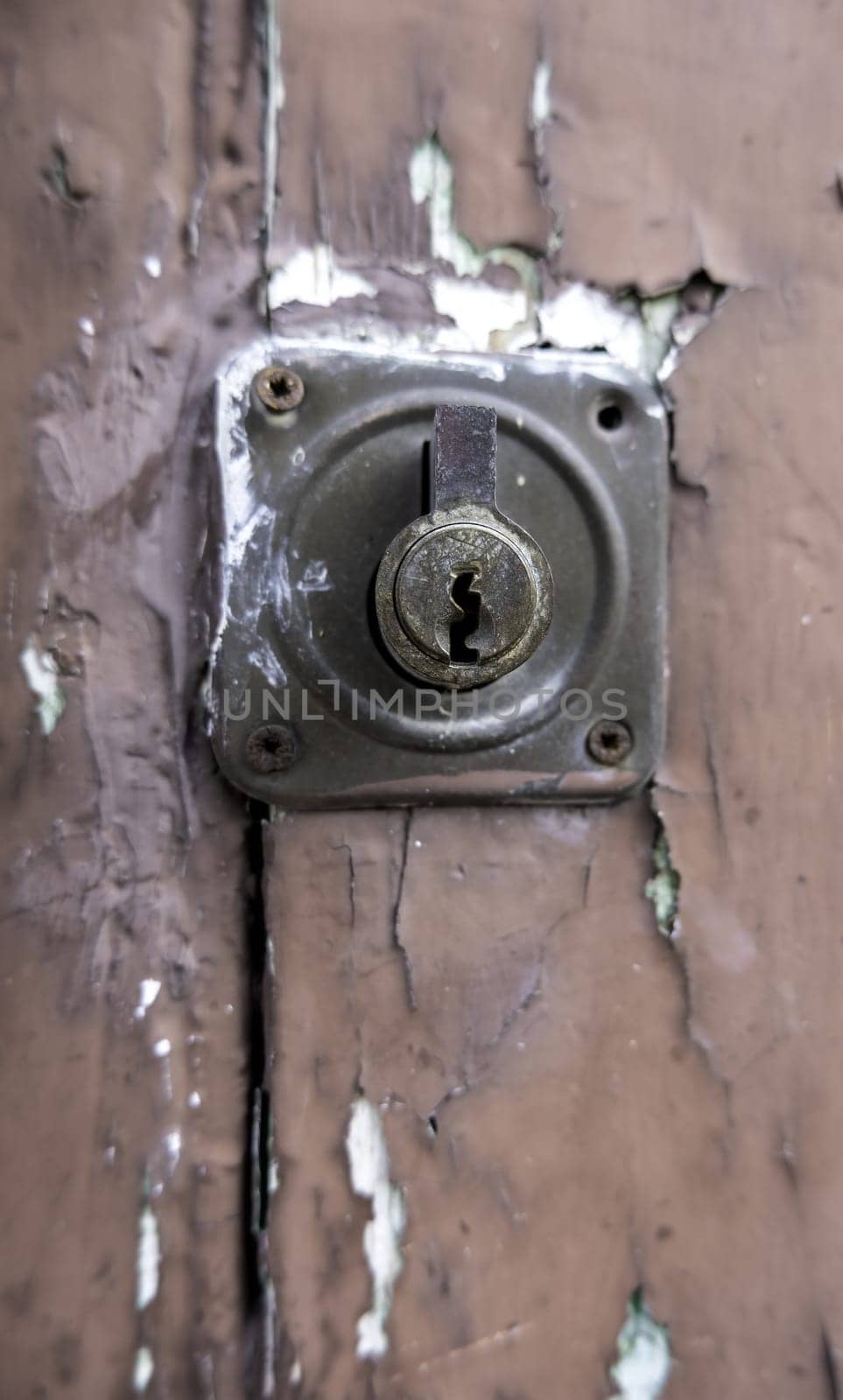 Detail of old damaged and abandoned wooden door, rust