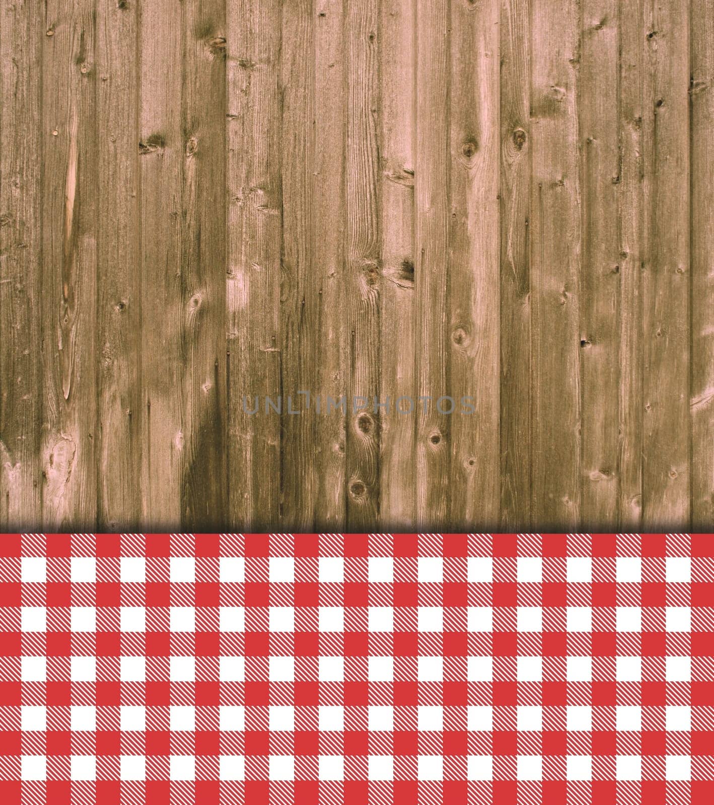 Old weathered wooden wall with red and and white checkered tablecloth